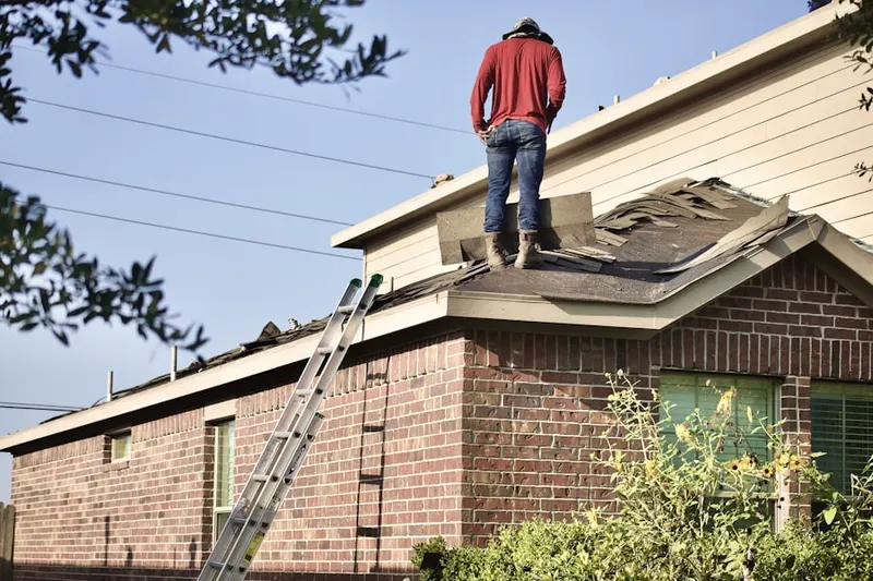 Professional roofer working on a residential roof in Montgomery Village